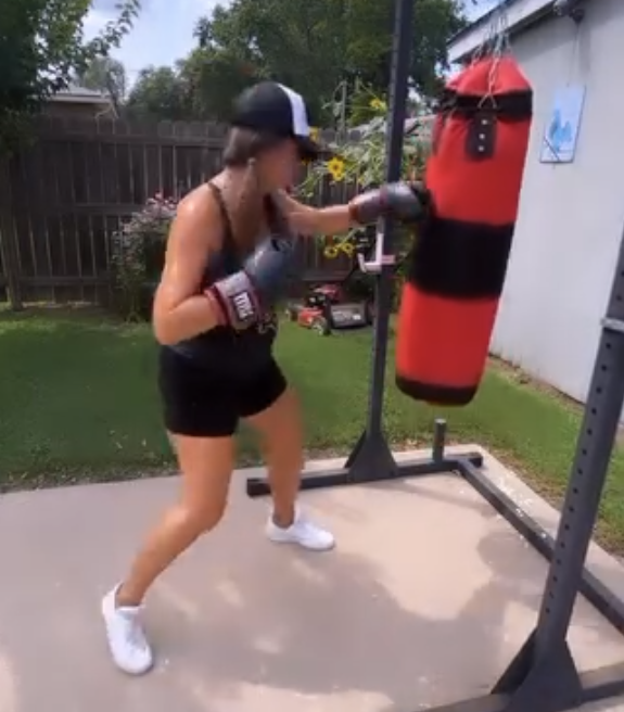 Michelle Long working the heavy bag during an outdoor training session